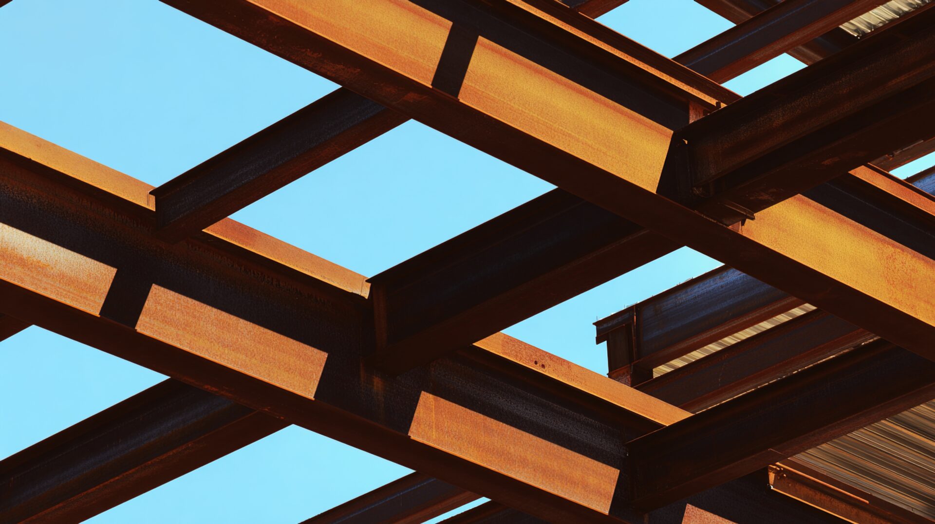 girder. A construction site with steel framework and architectural elements in an industrial setting under natural daylight. real-estate listings.